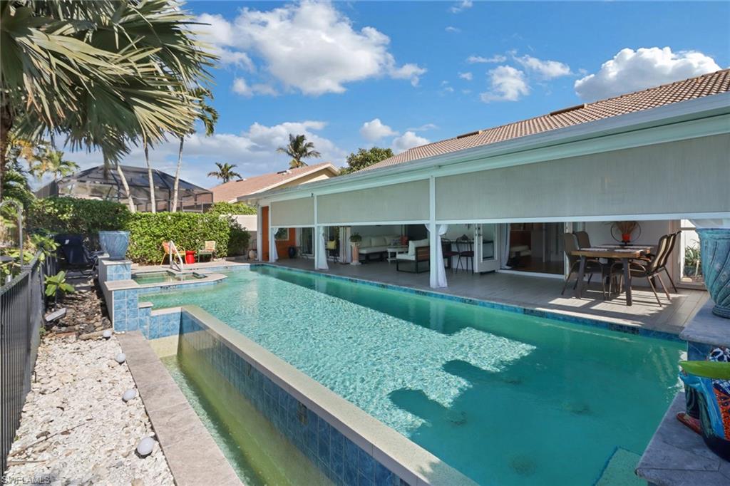 310 Fox Den Circle Naples, FL 34104 - Photo 45 of 46 a view of a house with backyard porch and sitting area