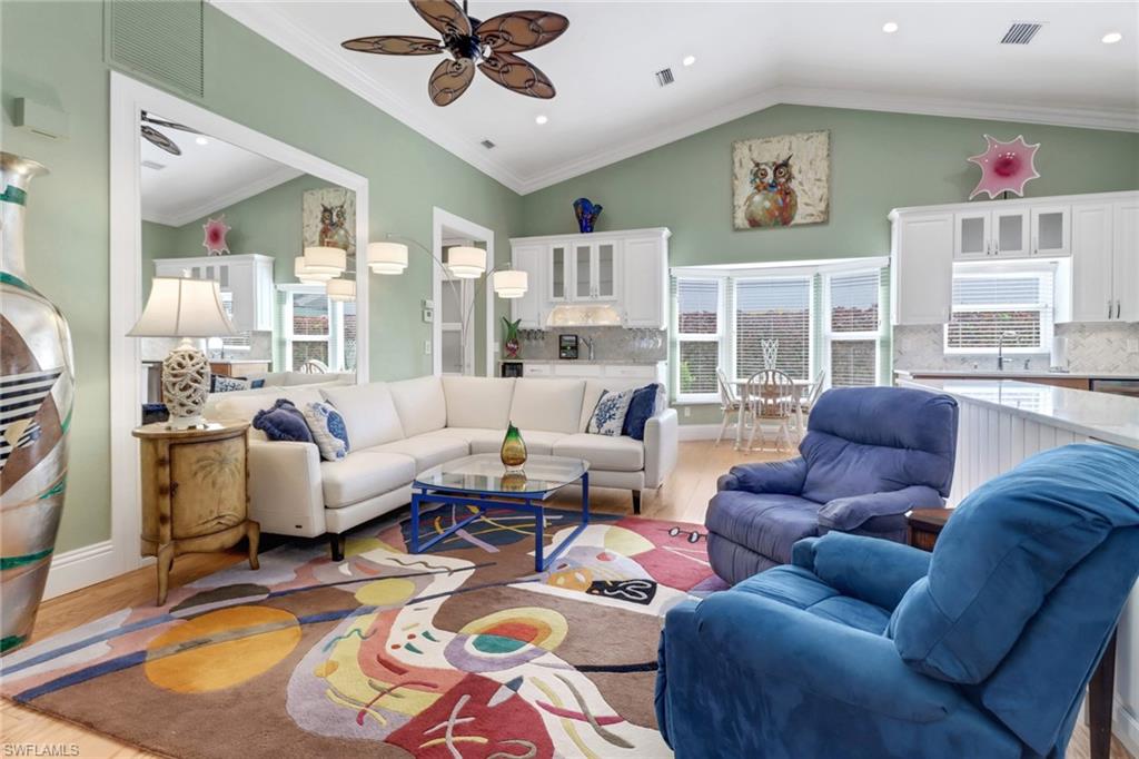310 Fox Den Circle Naples, FL 34104 - Photo 6 of 46 a living room with furniture wooden floor and a large window