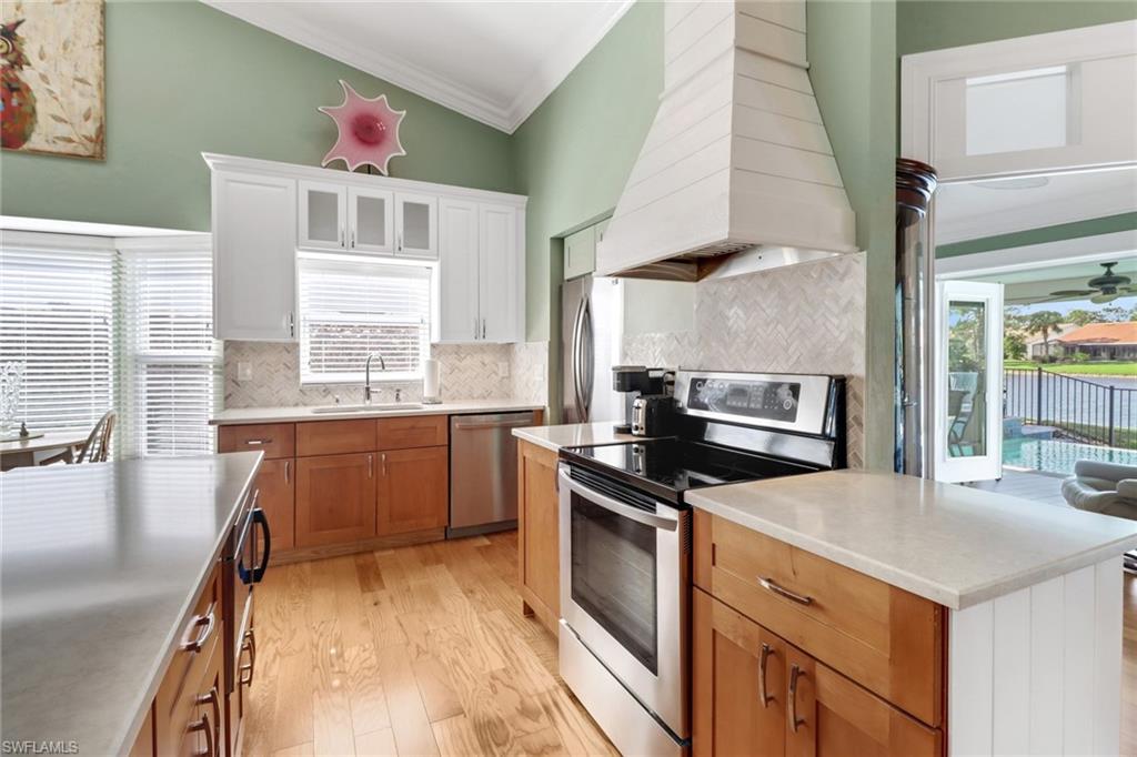 310 Fox Den Circle Naples, FL 34104 - Photo 7 of 46 a kitchen with a stove a sink and a microwave