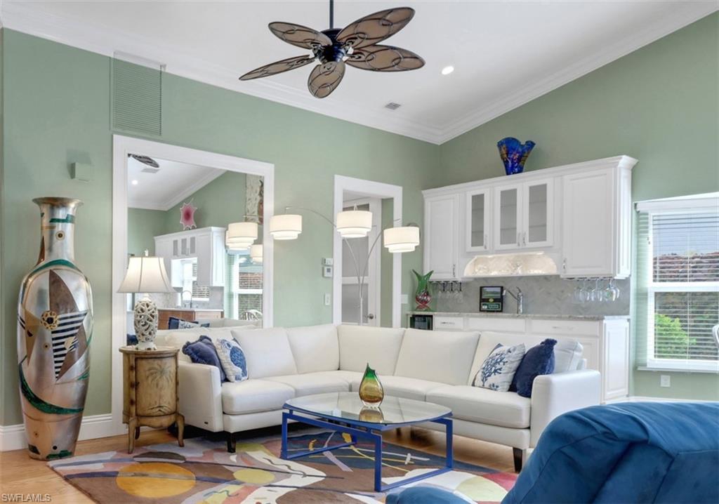 310 Fox Den Circle Naples, FL 34104 - Photo 9 of 46 a living room with furniture and a large window
