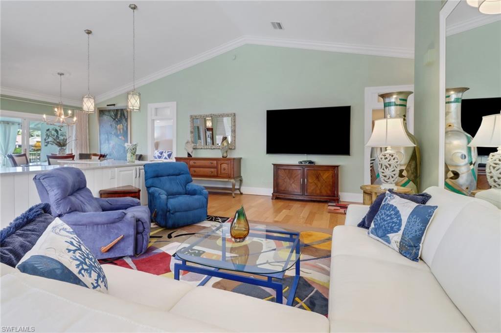 310 Fox Den Circle Naples, FL 34104 - Photo 10 of 46 a living room with furniture and a flat screen tv