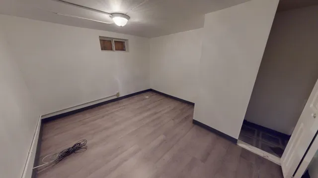 an empty room with wooden floor