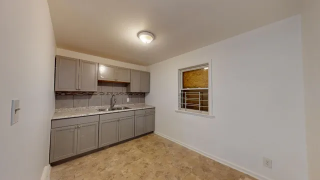 a view of a kitchen with two sink and a window