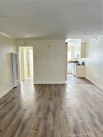 a view of a kitchen with a sink and a refrigerator