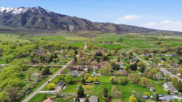 45 West 100 South Mendon, UT 84325 - Photo 57 of 64 Aerial view of residential area featuring a mountain backdrop