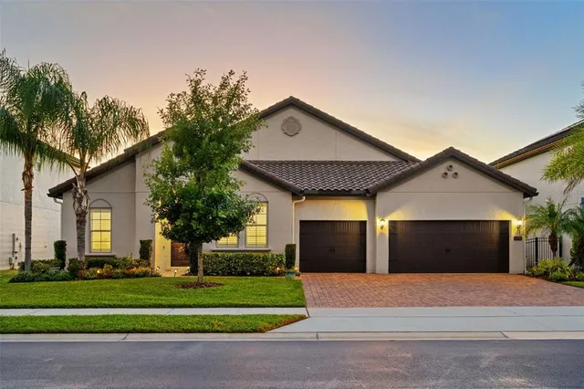 a front view of a house with a yard and garage