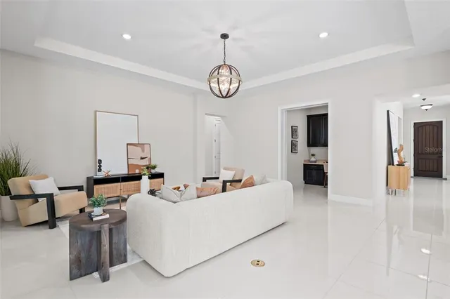 a living room with fireplace furniture and a view of kitchen