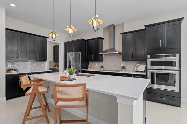a kitchen with a refrigerator a microwave a sink and cabinets