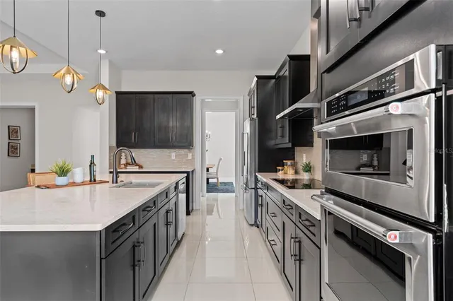 a kitchen with stainless steel appliances a stove and a sink
