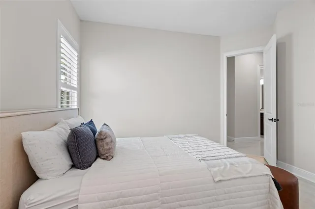 a bedroom with a bed and a window