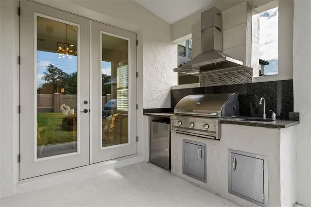 a kitchen with white cabinets and a stove