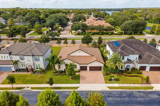 an aerial view of residential houses with outdoor space and swimming pool
