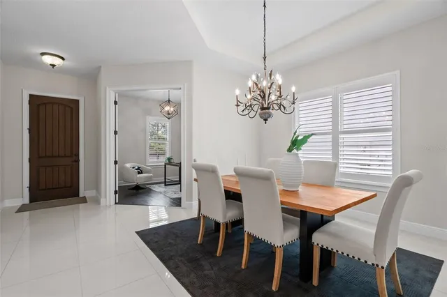 a view of a dining room with furniture and chandelier