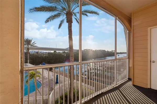 a view of a balcony with a yard