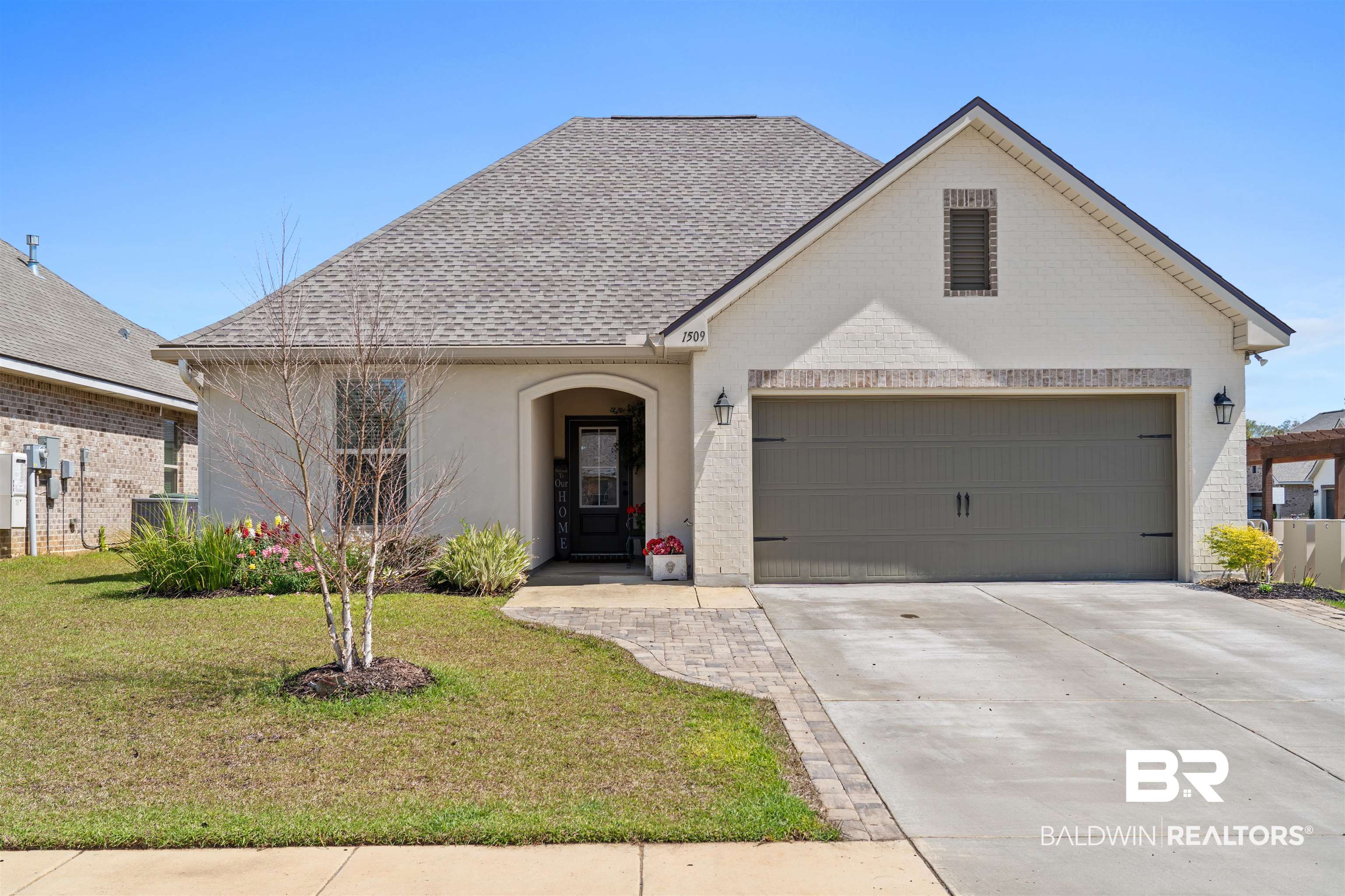 1509 Fenton Circle Foley, AL 36535 - Photo 2 of 34 French country inspired facade with driveway, an attached garage, a shingled roof, and a front yard