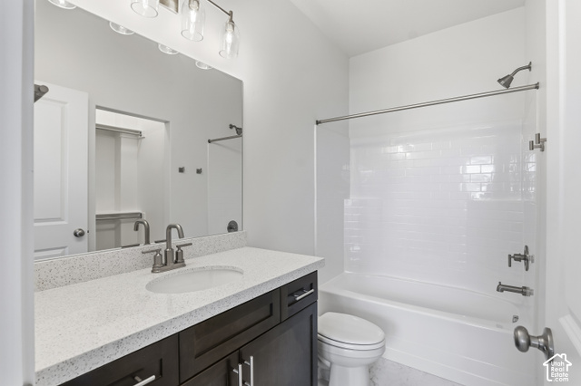 79 South Crimson Way West, Unit 307 Mapleton, UT 84664 - Photo 30 of 42 Contemporary bathroom featuring a dark wood-finish vanity with an integrated sink, a speckled light-toned countertop, and a sleek rectangular mirror