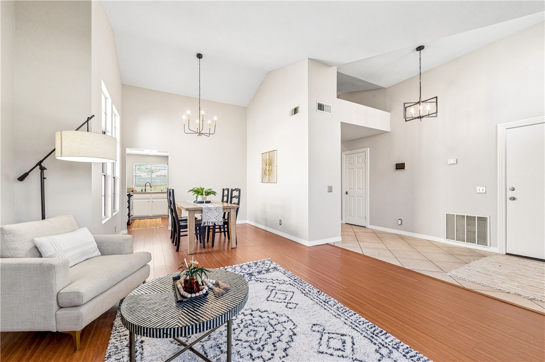 9146 Rangpur Circle Riverside, CA 92508 - Photo 13 of 52 a living room with furniture a dining table and a chandelier