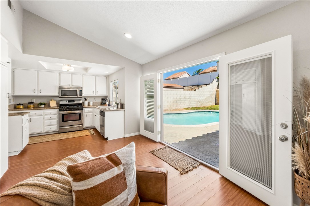9146 Rangpur Circle Riverside, CA 92508 - Photo 21 of 52 a kitchen with stainless steel appliances granite countertop a refrigerator and a stove top oven