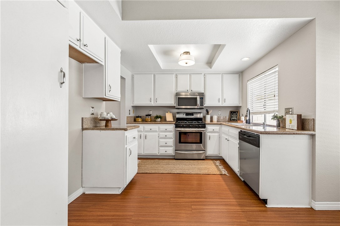9146 Rangpur Circle Riverside, CA 92508 - Photo 22 of 52 a kitchen with white cabinets stainless steel appliances and sink