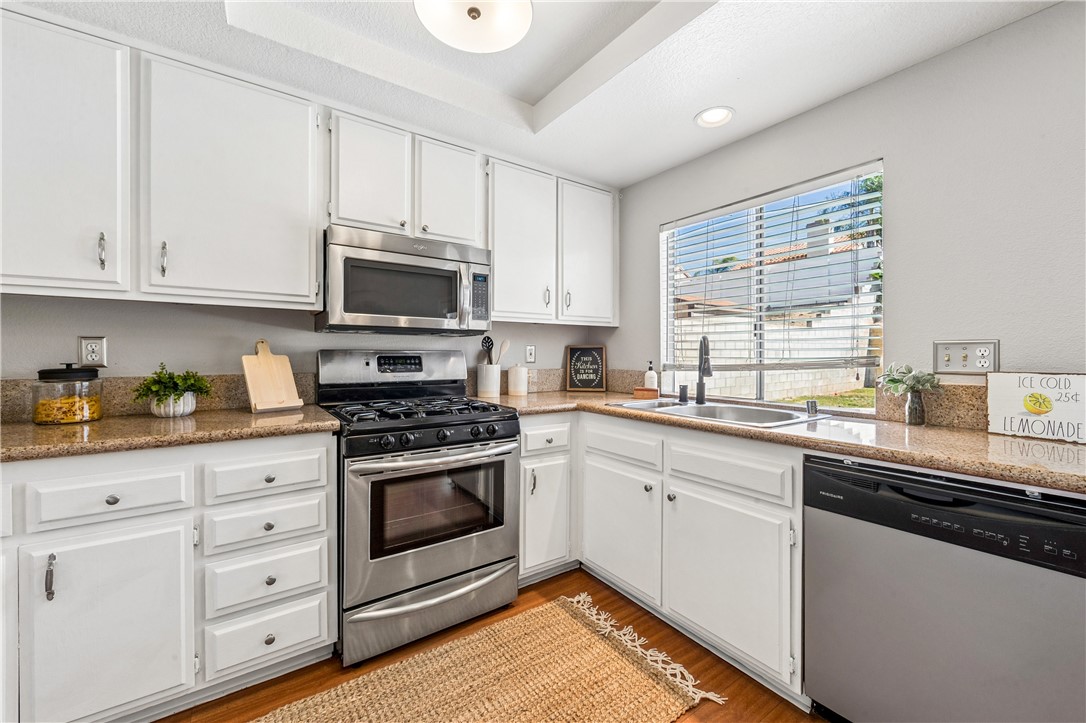 9146 Rangpur Circle Riverside, CA 92508 - Photo 24 of 52 a kitchen with granite countertop white cabinets and appliances