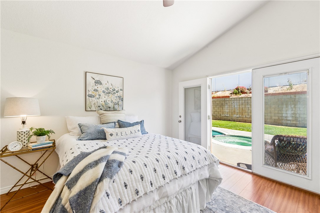 9146 Rangpur Circle Riverside, CA 92508 - Photo 32 of 52 a bedroom with a bed and a large window