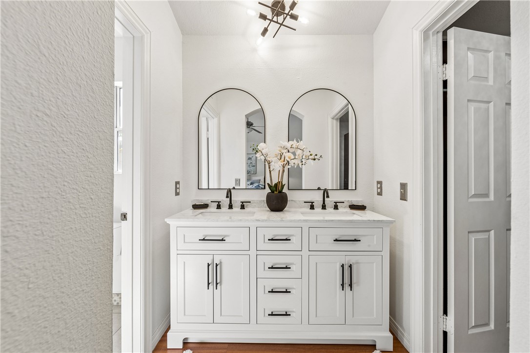 9146 Rangpur Circle Riverside, CA 92508 - Photo 36 of 52 a bathroom with a double vanity sink and a mirror