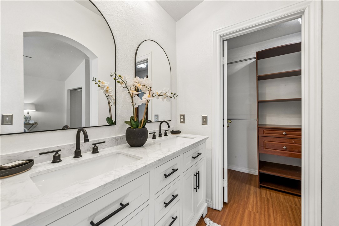 9146 Rangpur Circle Riverside, CA 92508 - Photo 38 of 52 a bathroom with a double vanity sink and a mirror