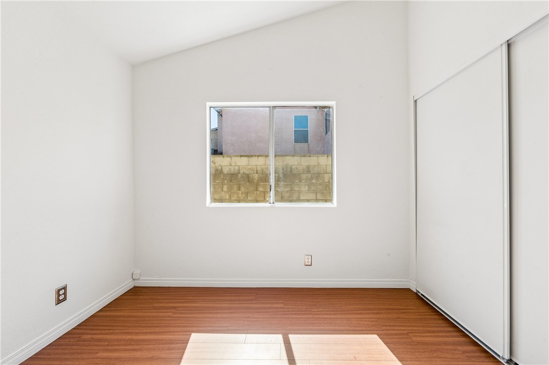 9146 Rangpur Circle Riverside, CA 92508 - Photo 40 of 52 a view of an empty room with wooden floor and a window