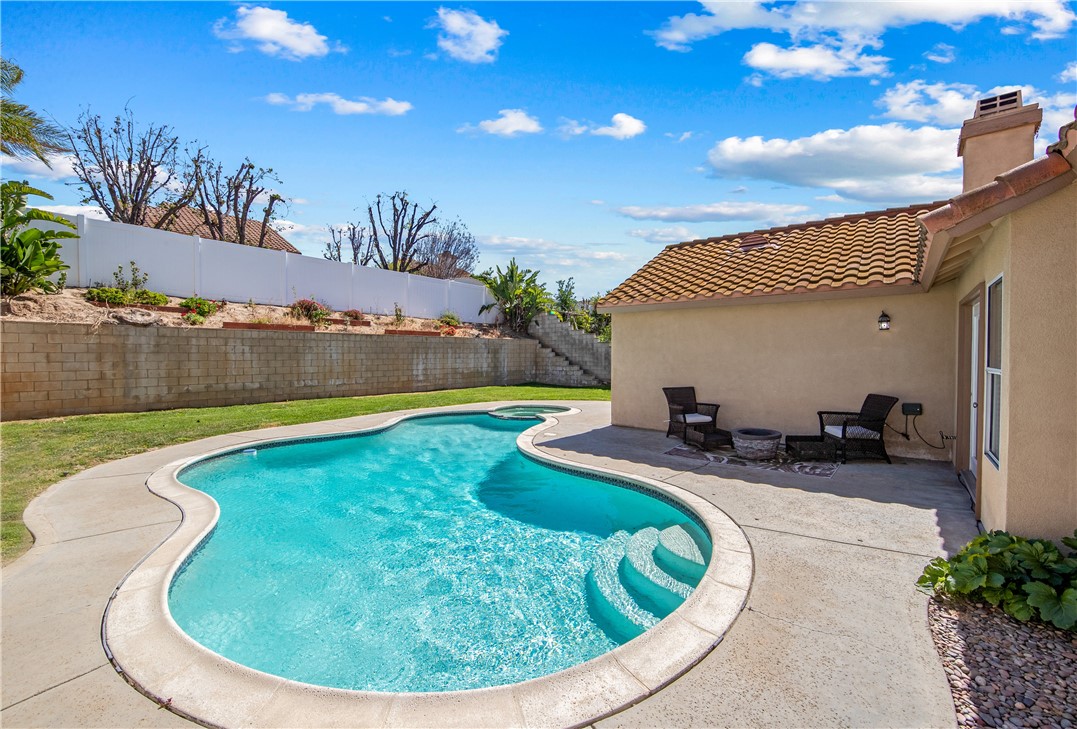 9146 Rangpur Circle Riverside, CA 92508 - Photo 4 of 52 a view of swimming pool with outdoor seating and house in the background