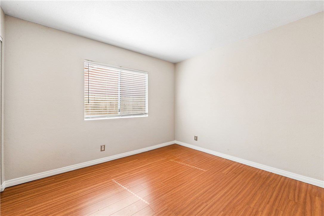 9146 Rangpur Circle Riverside, CA 92508 - Photo 45 of 52 an empty room with wooden floor and windows