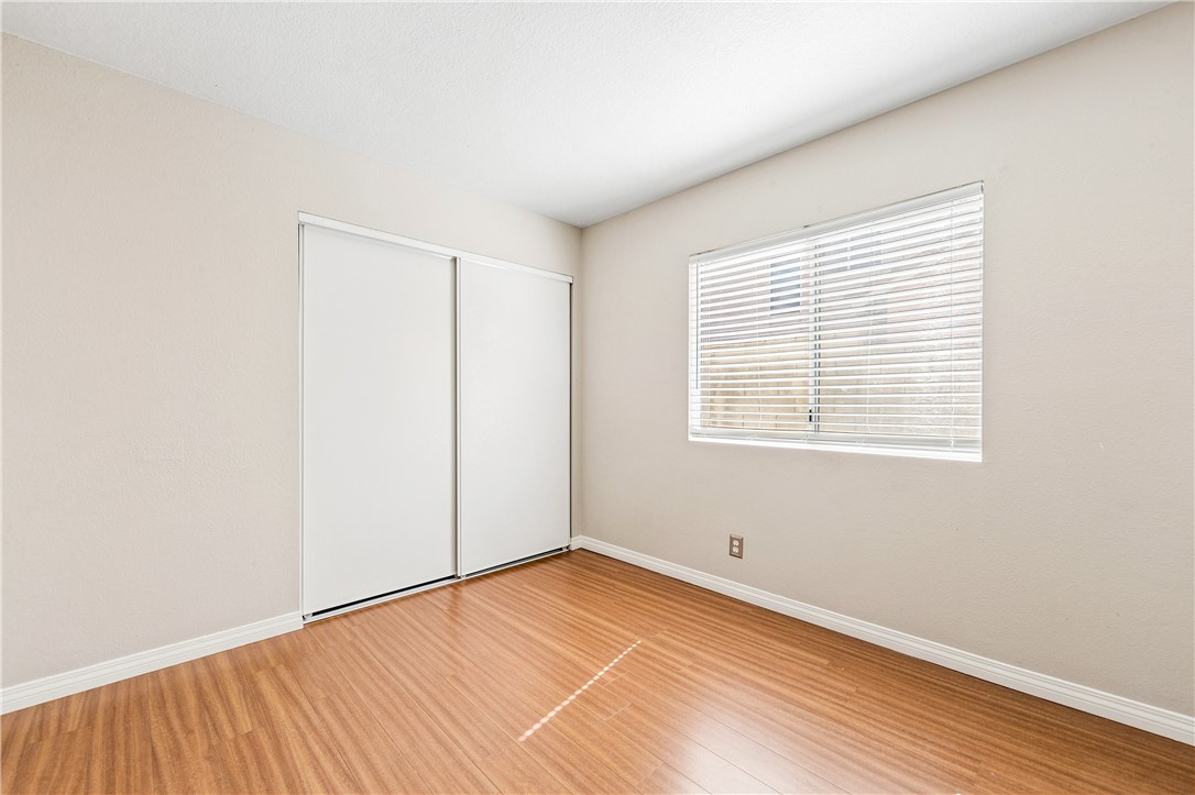 9146 Rangpur Circle Riverside, CA 92508 - Photo 46 of 52 a view of an empty room with wooden floor and a window