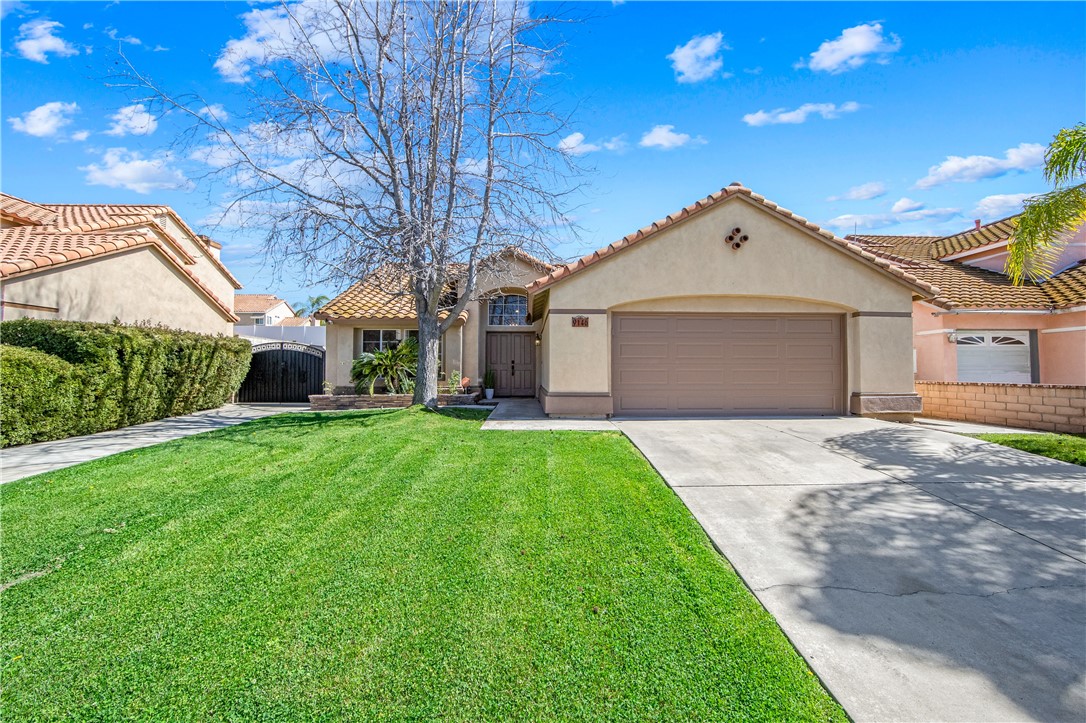 9146 Rangpur Circle Riverside, CA 92508 - Photo 5 of 52 a view of a yard in front of a house with plants and large tree