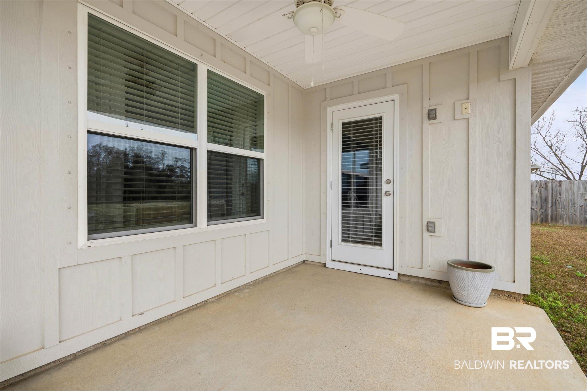 17041 Muse Street Loxley, AL 36551 - Photo 25 of 44 View of exterior entry featuring ceiling fan, a patio area, and board and batten siding