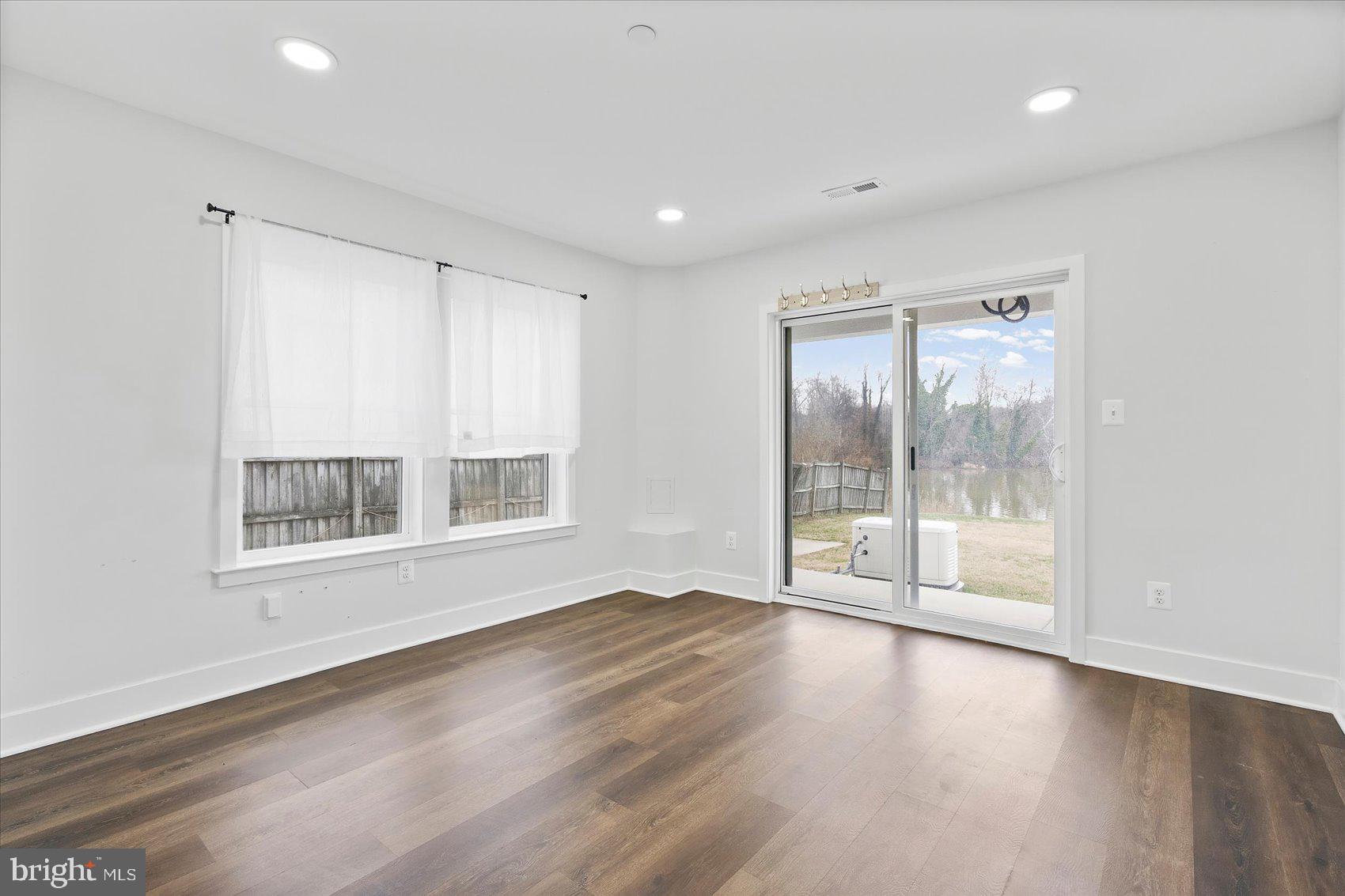 11030 Bird River Grove Road White Marsh, MD 21162 - Photo 14 of 53 a view of an empty room with wooden floor and a window