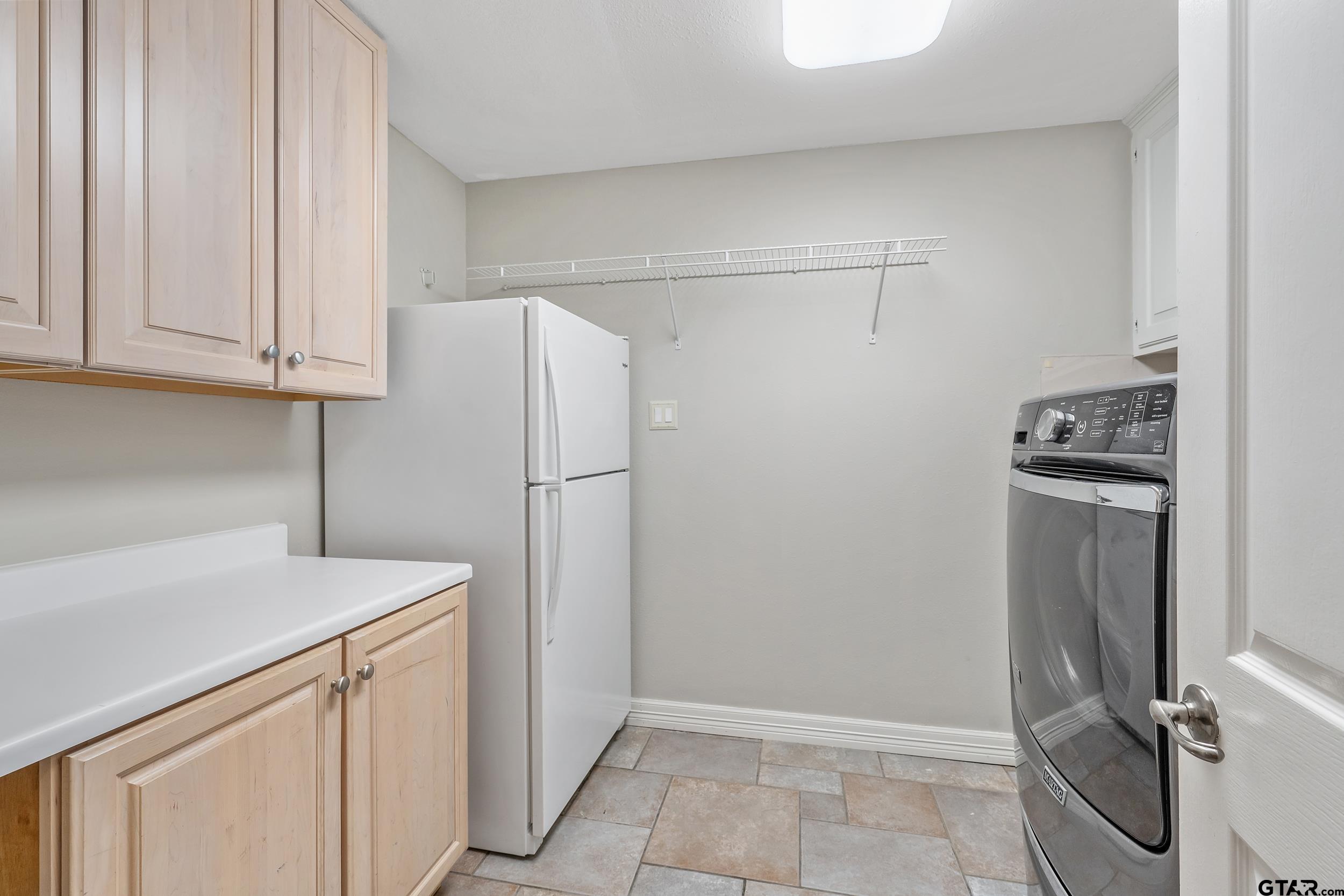231 West Cumberland Road Tyler, TX 75703 - Photo 19 of 48 a view of a kitchen with refrigerator and cabinet