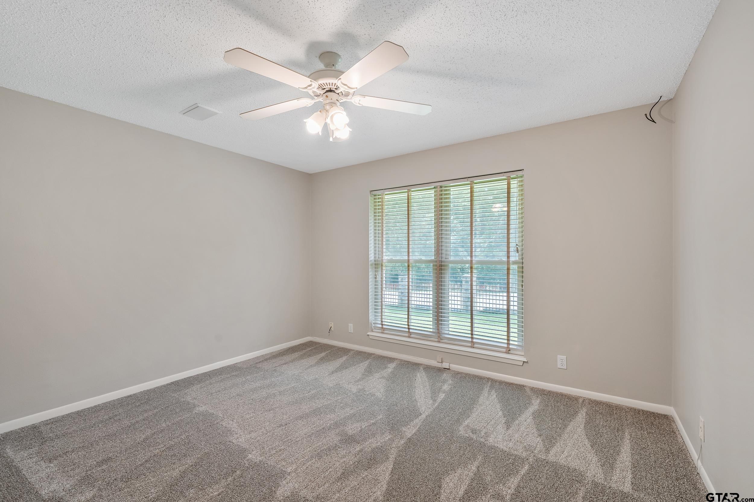 231 West Cumberland Road Tyler, TX 75703 - Photo 25 of 48 a view of an empty room with wooden floor and a window
