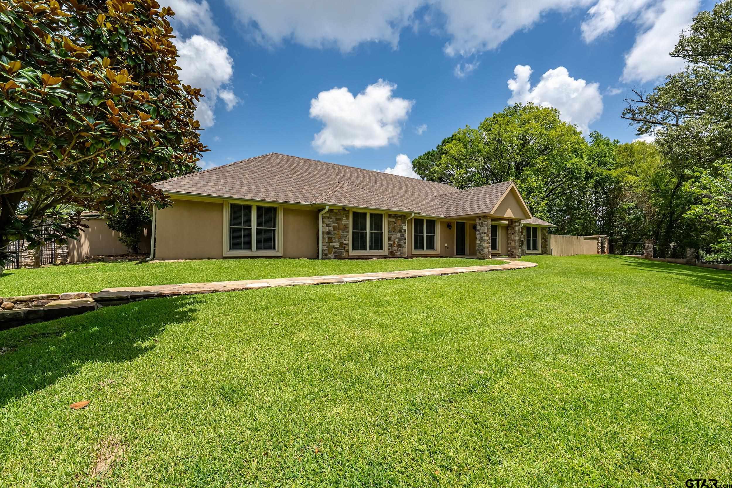 231 West Cumberland Road Tyler, TX 75703 - Photo 30 of 48 a front view of a house with a garden