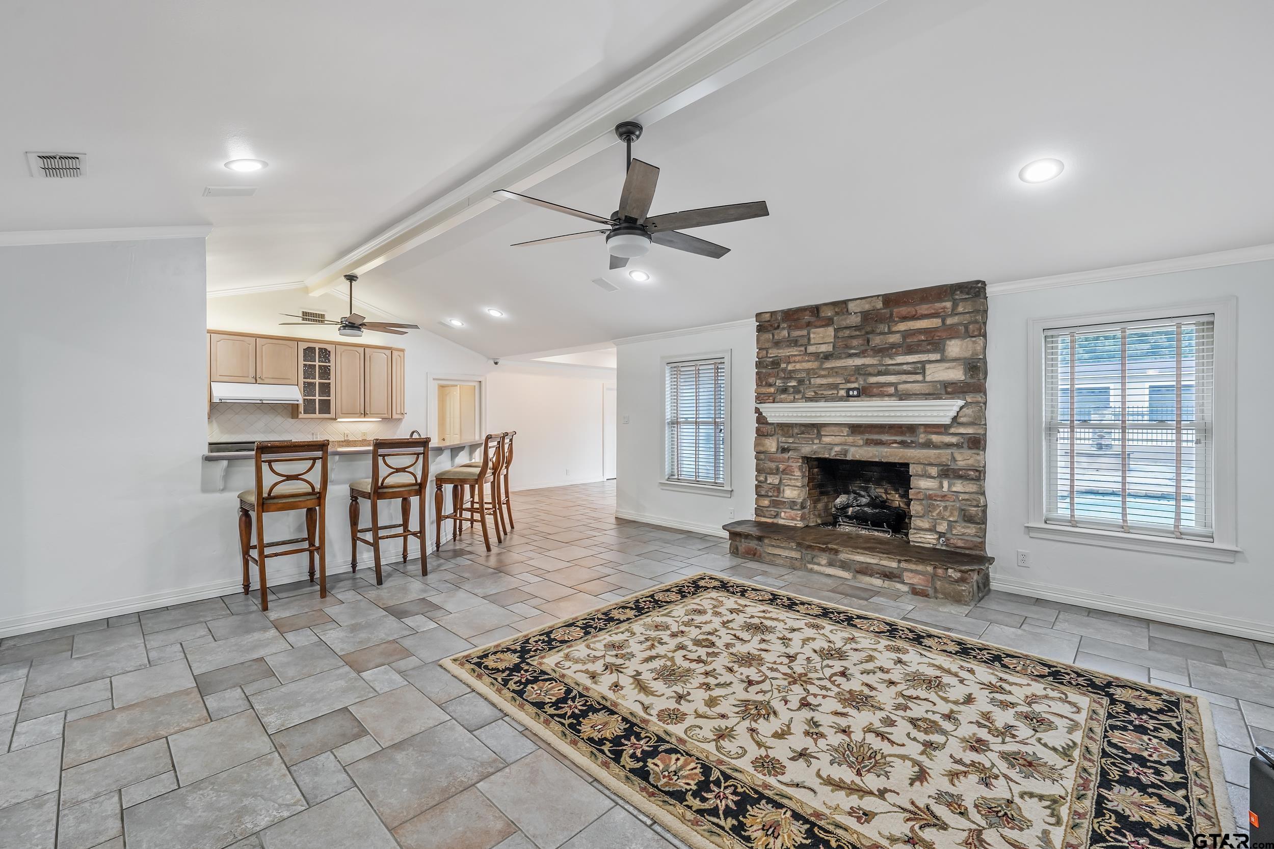 231 West Cumberland Road Tyler, TX 75703 - Photo 9 of 48 a living room with a fireplace and a table