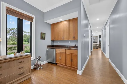 a bathroom with a granite countertop sink and a large mirror