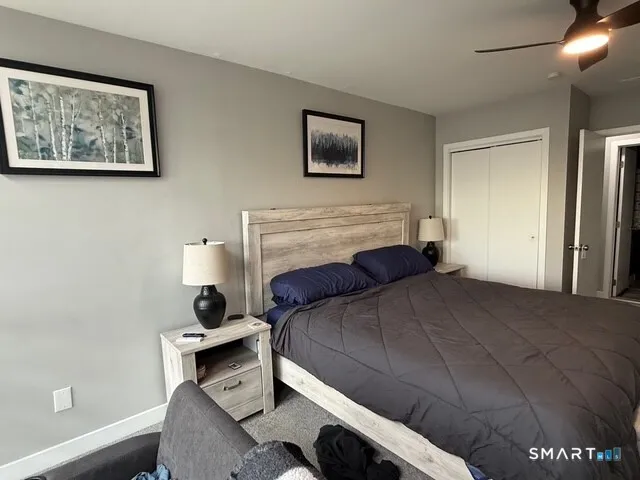 a bedroom with a bed and a desk