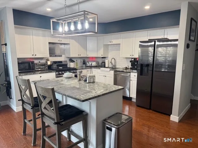a kitchen with a dining table and chairs