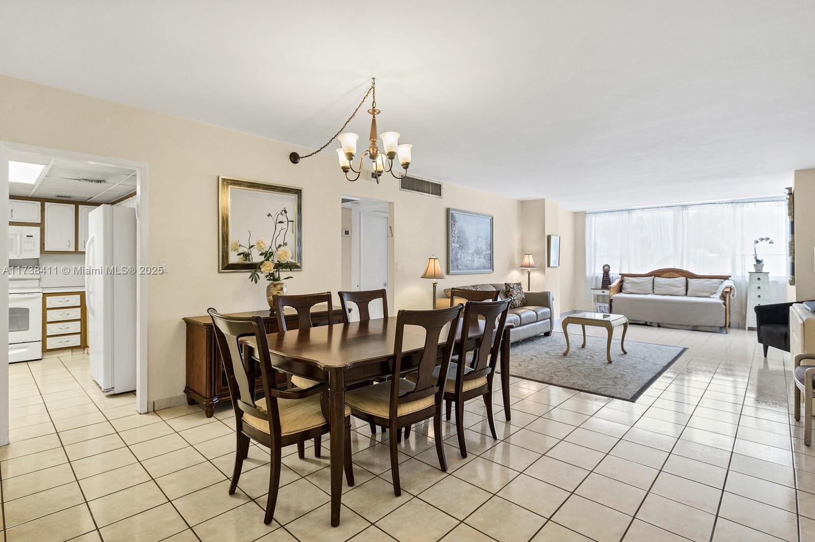 5005 Collins Avenue, Unit 724 Miami Beach, FL 33140 - Photo 1 of 15 a view of a dining room with furniture