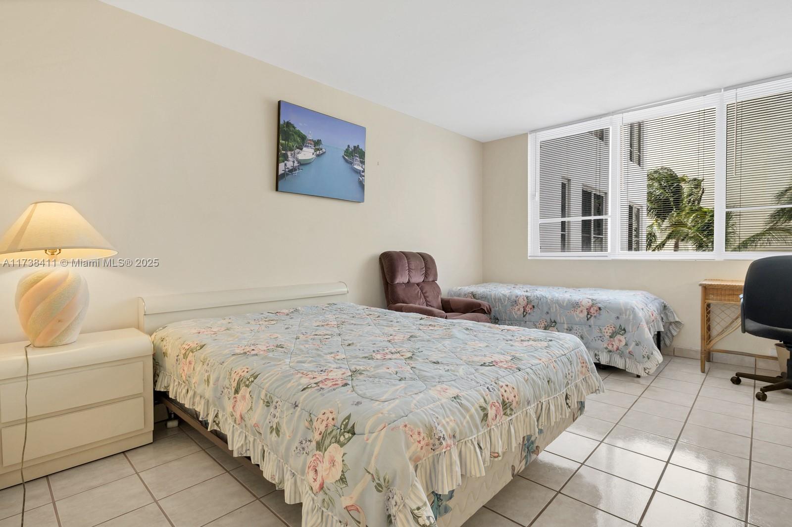 5005 Collins Avenue, Unit 724 Miami Beach, FL 33140 - Photo 12 of 15 a bedroom with a bed and a large window