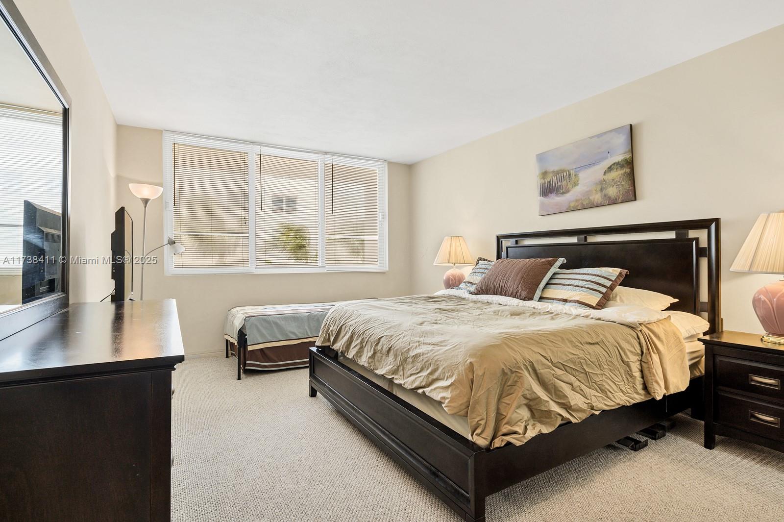 5005 Collins Avenue, Unit 724 Miami Beach, FL 33140 - Photo 8 of 15 a bedroom with a bed and a window