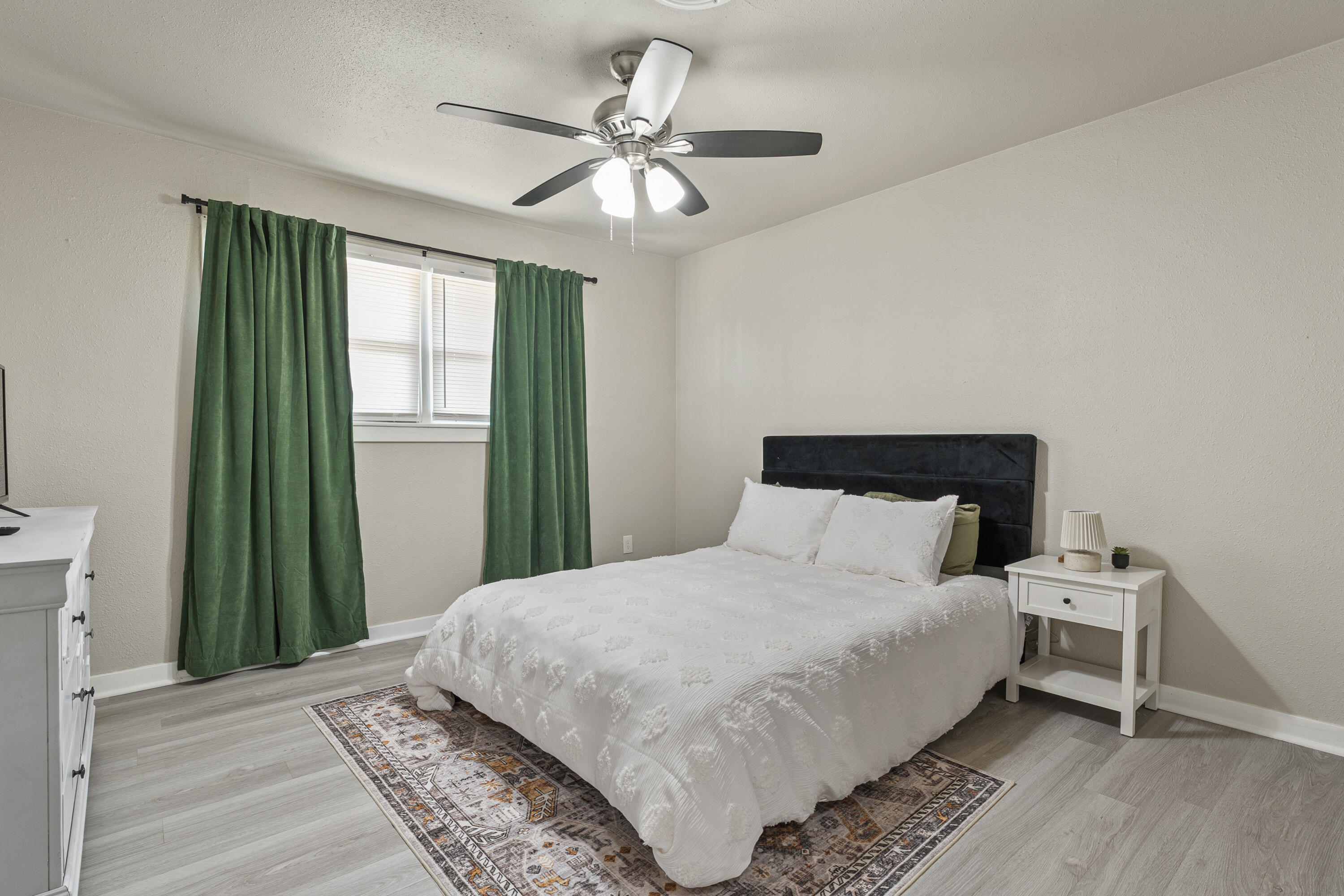 5217 9th Street Lubbock, TX 79416 - Photo 11 of 18 a bedroom with a bed and a window