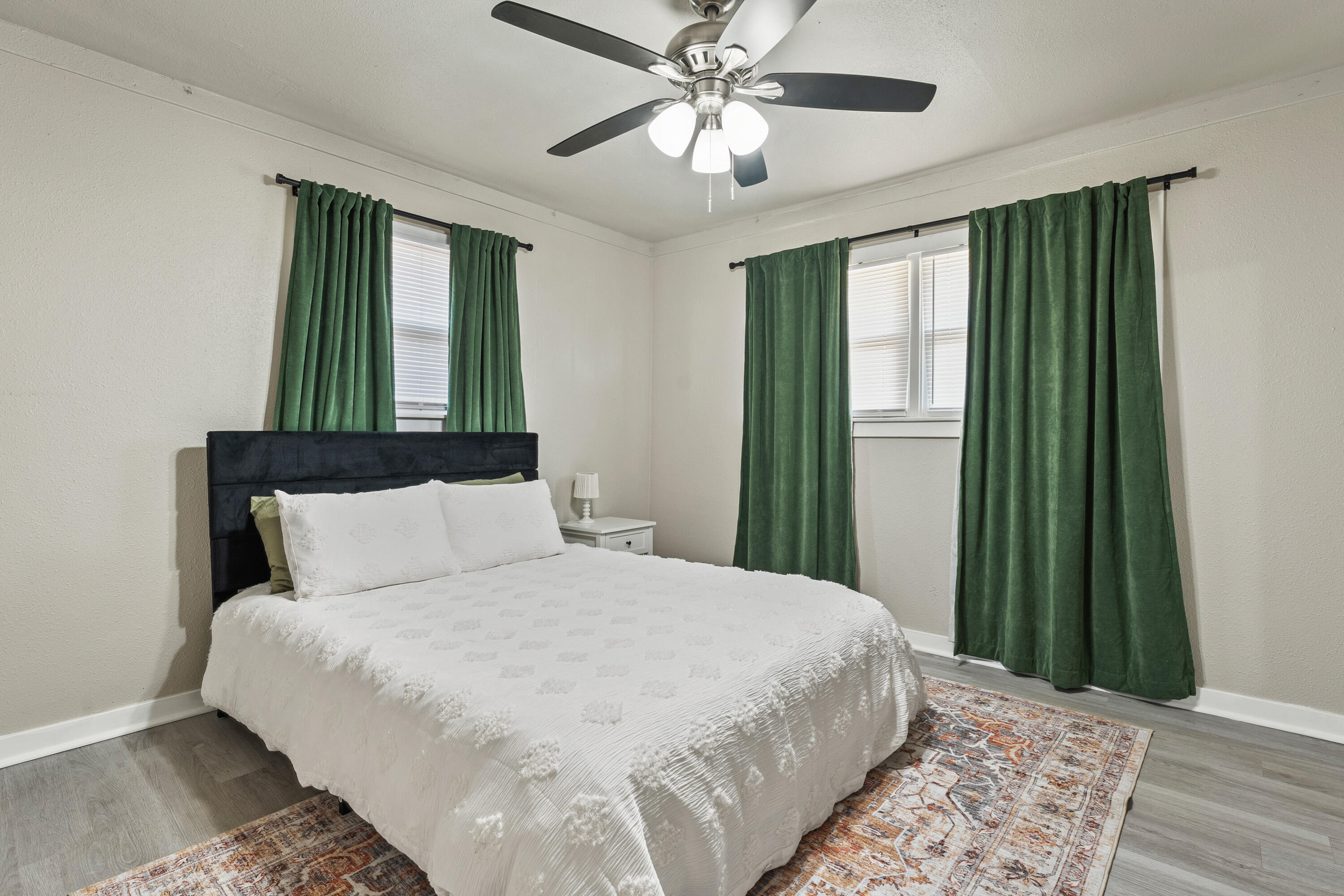 5217 9th Street Lubbock, TX 79416 - Photo 13 of 18 a bedroom with a large bed and a window