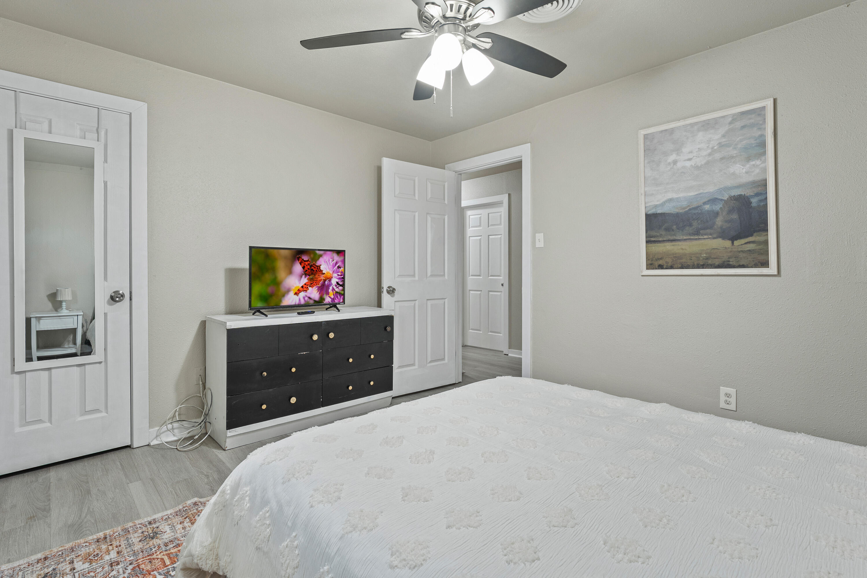 5217 9th Street Lubbock, TX 79416 - Photo 14 of 18 a bedroom with a bed and a dresser