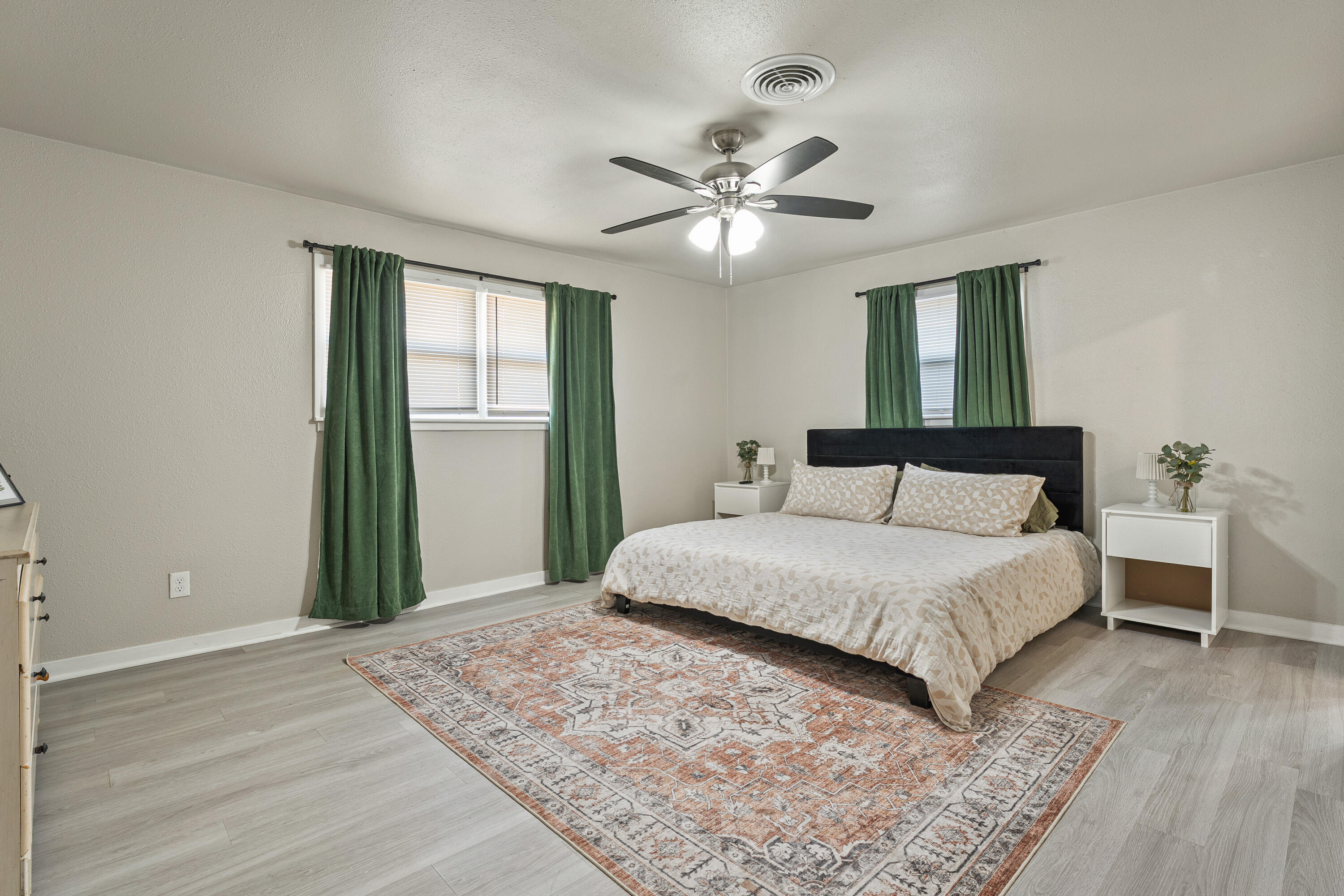 5217 9th Street Lubbock, TX 79416 - Photo 15 of 18 a bedroom with a large bed and a window