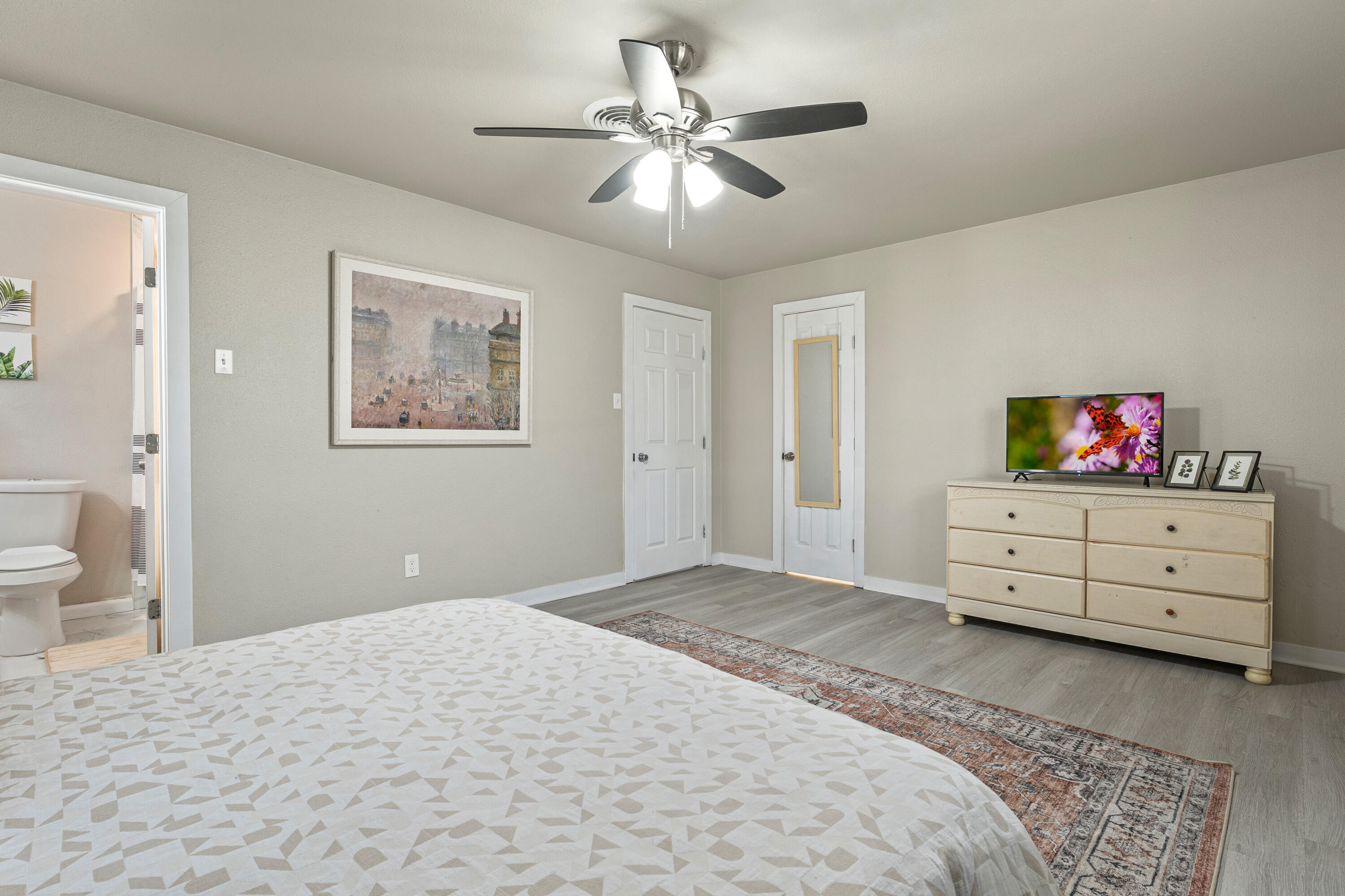 5217 9th Street Lubbock, TX 79416 - Photo 16 of 18 a bedroom with a bed and a dresser