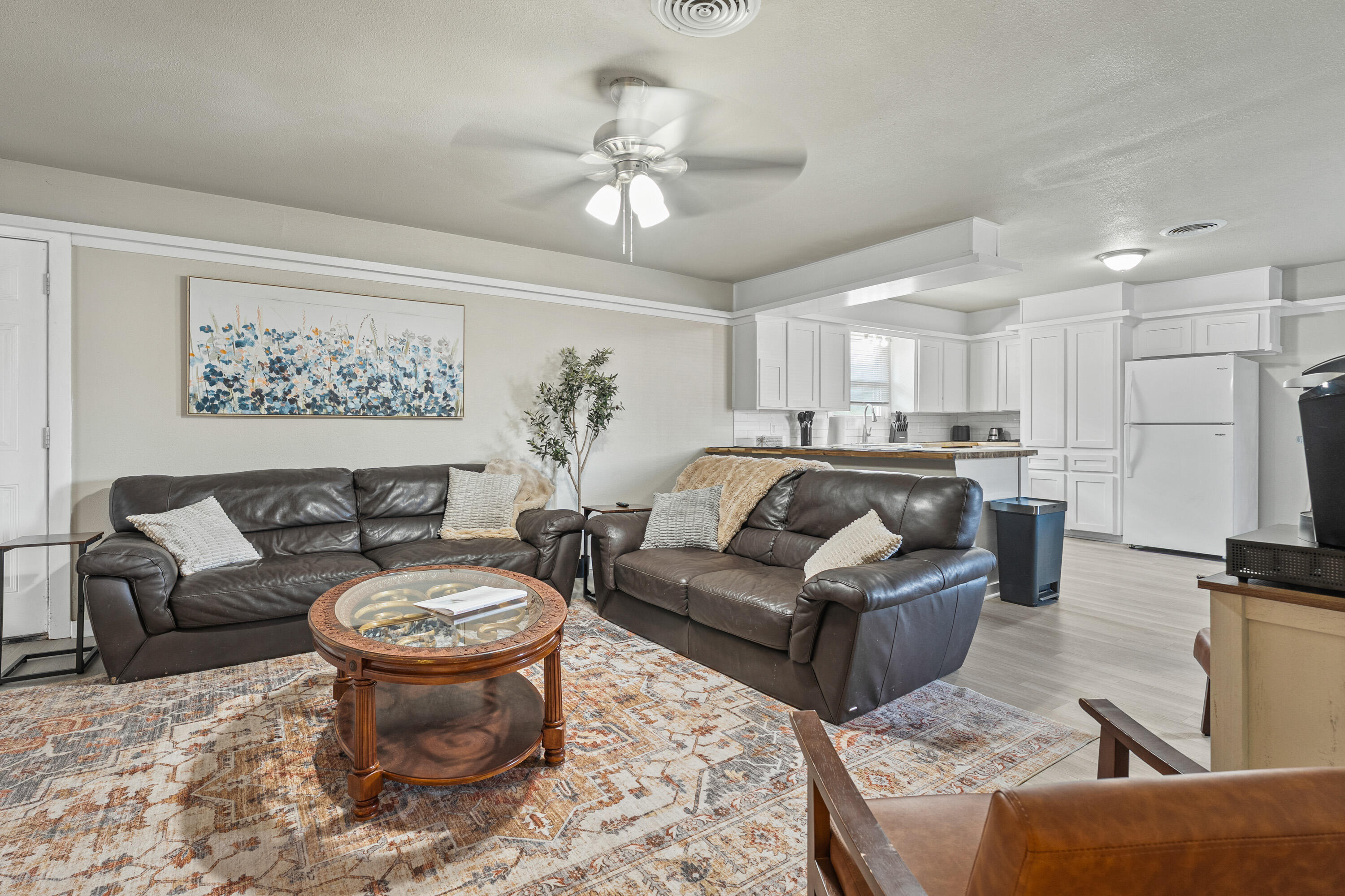 5217 9th Street Lubbock, TX 79416 - Photo 2 of 18 a living room with furniture and a chandelier